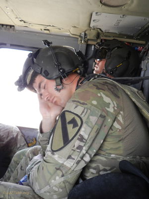 Crew Chief SGT Hussey sleeping in the back of the hawk and CPT Ryan Whipple in the background sleeping as well
Mike Caudle Photo
