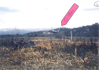 C-130 Shoot Down B
Photo provided by Bob Witt

A Shau Valley April 1968
All of these C-130 Shoot Down photos came from the son of the C-130 navigator Roger Carr. The pictures were taken by a grunt medic who was KIA in June 1968. If you look closely you can see a crewman jumping from the rear ramp. In the foreround yo can see grunts and a NVA bulldozer

