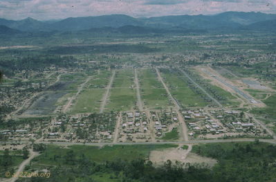 Aerial of the Golf Course
John Keller Photo

The Golf Course, looking south, April 2, 1967. A C-130 back taxi for turnaround on the runway. The A/227 Company area is the 1st road to the left of CH-47's at the south end.
