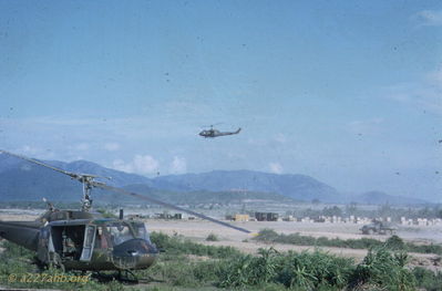 #64-13740 and 1LT Pearson
John Keller Photo

#64-13740 in 1966 with 1LT Bill Pearson sitting in a troop seat reading a book while we wait for a flight. Location has been identified as LZ English.

