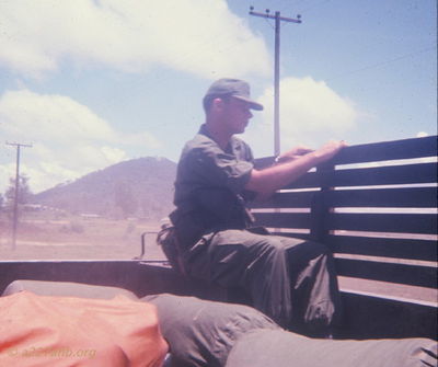 Ernie Kramer 
Bob Kelly Photo

Ernie Kramer in the back of a 3/4 ton taking us from the airstrip to temporary quarters in An Khe

