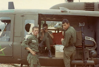Milo E. Schlaudraff, Jim King and Unknown
Reg Nelson Photo

Left: SP4 Milo E. Schlaudraff, Crew Chief on 63-12964 in 1966
From Chuck Stevens CE: "On the far right is Jim King. the one with the camera I do not know."

