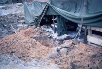 New bunker under construction
Bob Kelly Photo

D/227. Camp Evans. Bob Kelly digs new bunker with earthen seats. Also digs trench from betwen two living areas into bunker. Rocket hit, roll into trench, make way to bunker!
