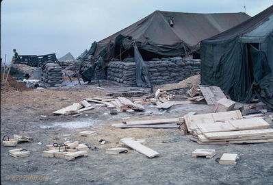 Scrounging wood for floor
Bob Kelly Photo

D/227. Camp Evans. Busting up rocket boxes and scrounging wood to construct wooden floor.

