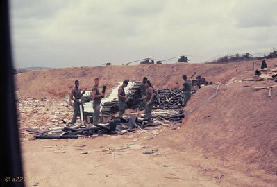 Rocket Dump
Bob Kelly Photo

D/227. Camp Evans. Rocket Dump. Removing the protective sleeves and screwing warheads on.

