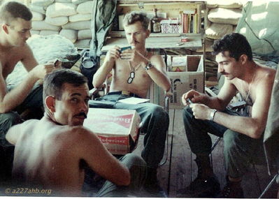 Chesnut, Goshert,Tornillo, and Johnson
Dave Jones Photo

Around the table from far left:
    John Chesnut, Jeff Goshert, James Tornillo and Nick Johnson (turned around looking at camera).
Camp Evans 1968

