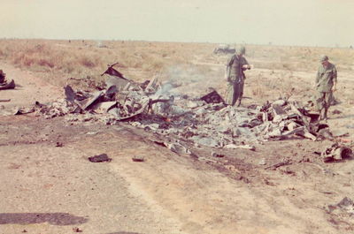 Results of mid-air
Ron Dillard Photo

The burned aircraft are the results of a mid-air that I was involved investigating. One ship cut the mast off the other during a close 2 ship formation. 

