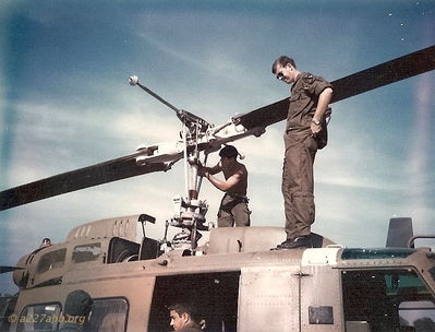 Dwayne Guidry standing on top of helicopter with maintenance officer.
Dwayne Guidry Photo

Lai Khe 1970 - 1971
