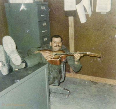 Sgt Howell again
Rickey McKay photo

 Sargent Howell playing his guitar 
