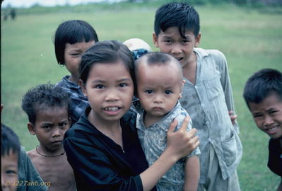More kids at Ham Tam
Bob Kelly Photo

Young girl babysitting younger brother. Ham Tam. Nice village.
