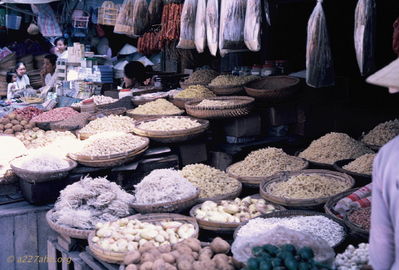 Noodles, Potatoes?
Bob Kelly Photo

Phan Thiet market. Noodles, potatoes, chutes, hanging dried peppers and ??

