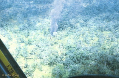 Fire Starting to Smolder
John LaDue Photo

From Bob Kelly: " Both of our hydraulic systems were shot out and being a charlie model we lost control. The nose pitched up then we rolled to an inverted position. Our instuctors were right. A Huey will not fly upside down. This was not a thick jungle and you can see from the pictures there was plenty of bare ground to hit. We got lucky and our fall was broken by a tree. Otherwise I would not be writing this!"

