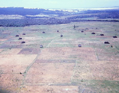 ARVN APC's
John LaDue Photo

Here's a photo I took of some ARVN APC's up in the Le Hong Phong forest. I asuume that I was flying escort for the Huey that's sitting in the middle. Note the "Twin Lakes" and sand dunes in the background. This was taken probably in June or July of 67. If I were to venture a guess, I'd say that on the Phan Thiet "Black Market", these APC's were probably described as "Low Mileage" and "No bullet holes". :-) I think that this was the only time I ever saw more than 1 or 2 of them together. 
