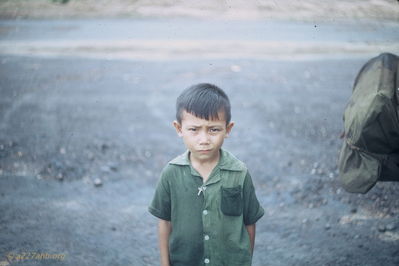 Catholic Kid
Jim Puhala Photo

Taken at Song Mau. Note the crucifix.

