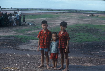 Three local kids
Jim Puhala Photo

Helicopters, at least the guns, were kid magnets.
This photo was taken at Song Mau. We spent a lot of time there - waiting. Weâ€™d put out a recon patrol in the morning. Theyâ€™d recon for a while; if they didnâ€™t find anything, weâ€™d pick them up and put them someplace else. If they did find something, weâ€™d do a CA.

