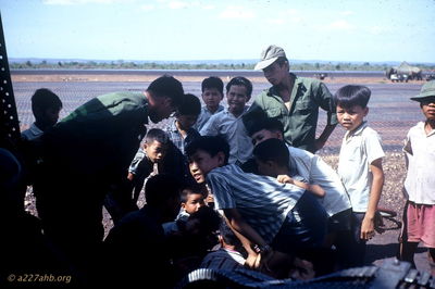 Spectator Sport Cricket Fight
Jim Puhala Photo

The kids would stage cricket fights. Theyâ€™d get a couple of crickets, rile them up by jabbing them with twigs and let them go after each other.
This photo was taken at Song Mau. We spent a lot of time there - waiting. Weâ€™d put out a recon patrol in the morning. Theyâ€™d recon for a while; if they didnâ€™t find anything, weâ€™d pick them up and put them someplace else. If they did find something, weâ€™d do a CA.
