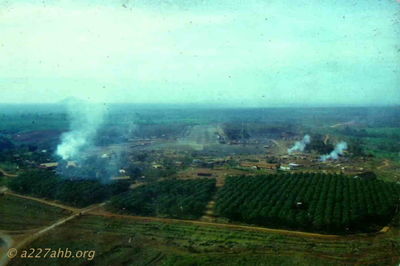 Quan Loi
Howard Burbank Photo

A/227 was stationed here for about a week when we first moved south to III Corps. View looking down main runway with artillary firing.
